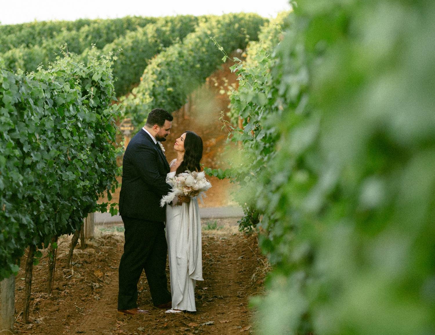 bride and groom in the vines at Tumwater Vineyard